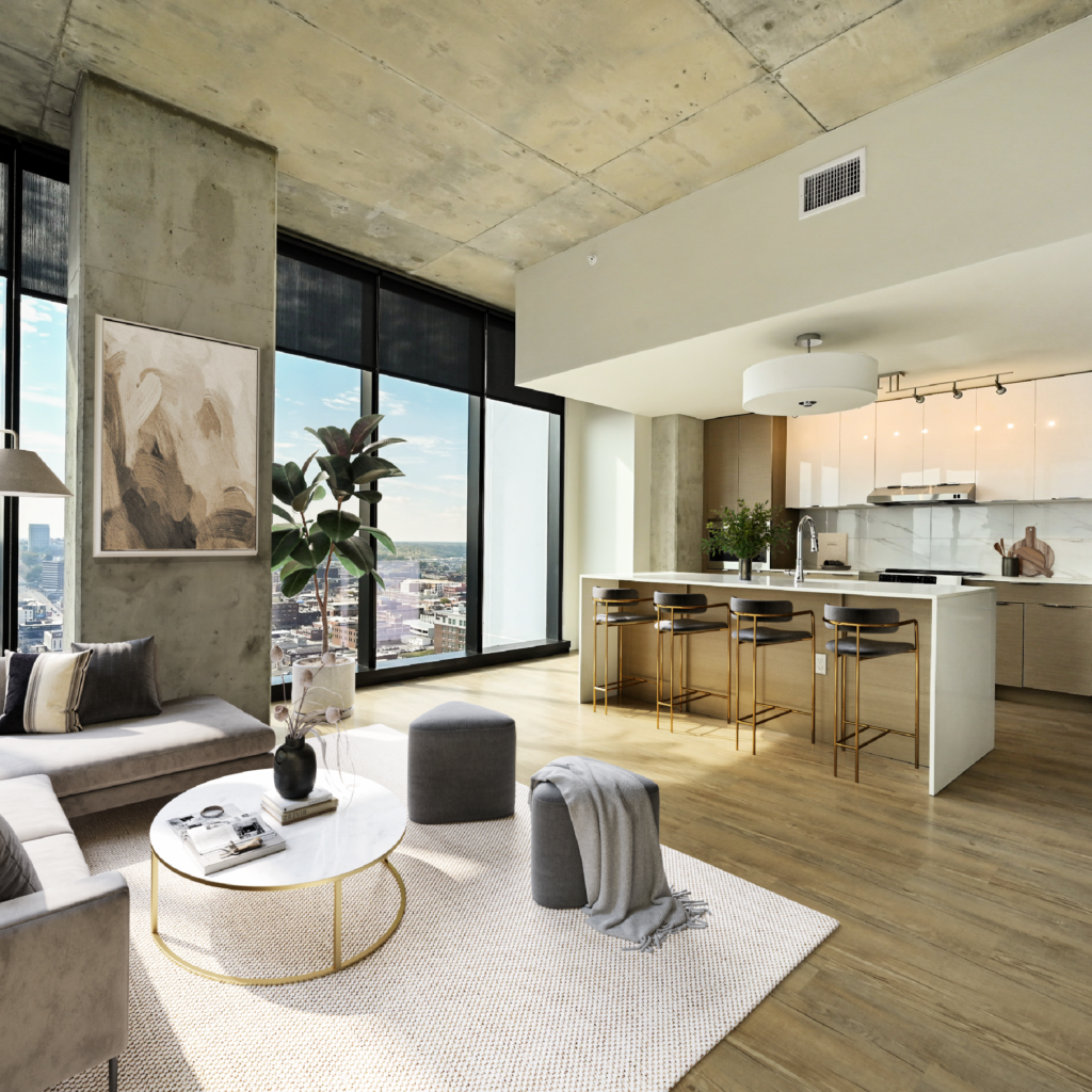 The living room and kitchen space of an apartment home in Three Light Luxury Apartments.