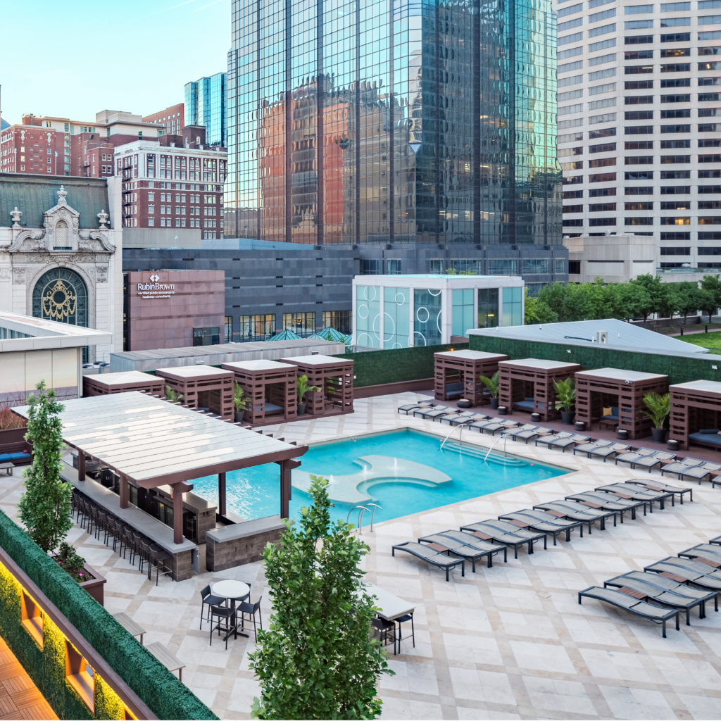 An aerial view of the pool at One Light Luxury Apartments featuring the cabanas.